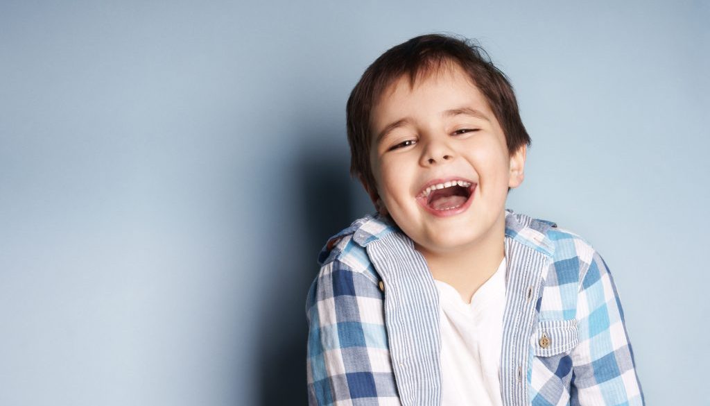 Portrait,Of,Happy,Joyful,Laughing,Beautiful,Little,Boy,On,Blue