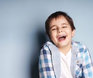 Portrait,Of,Happy,Joyful,Laughing,Beautiful,Little,Boy,On,Blue